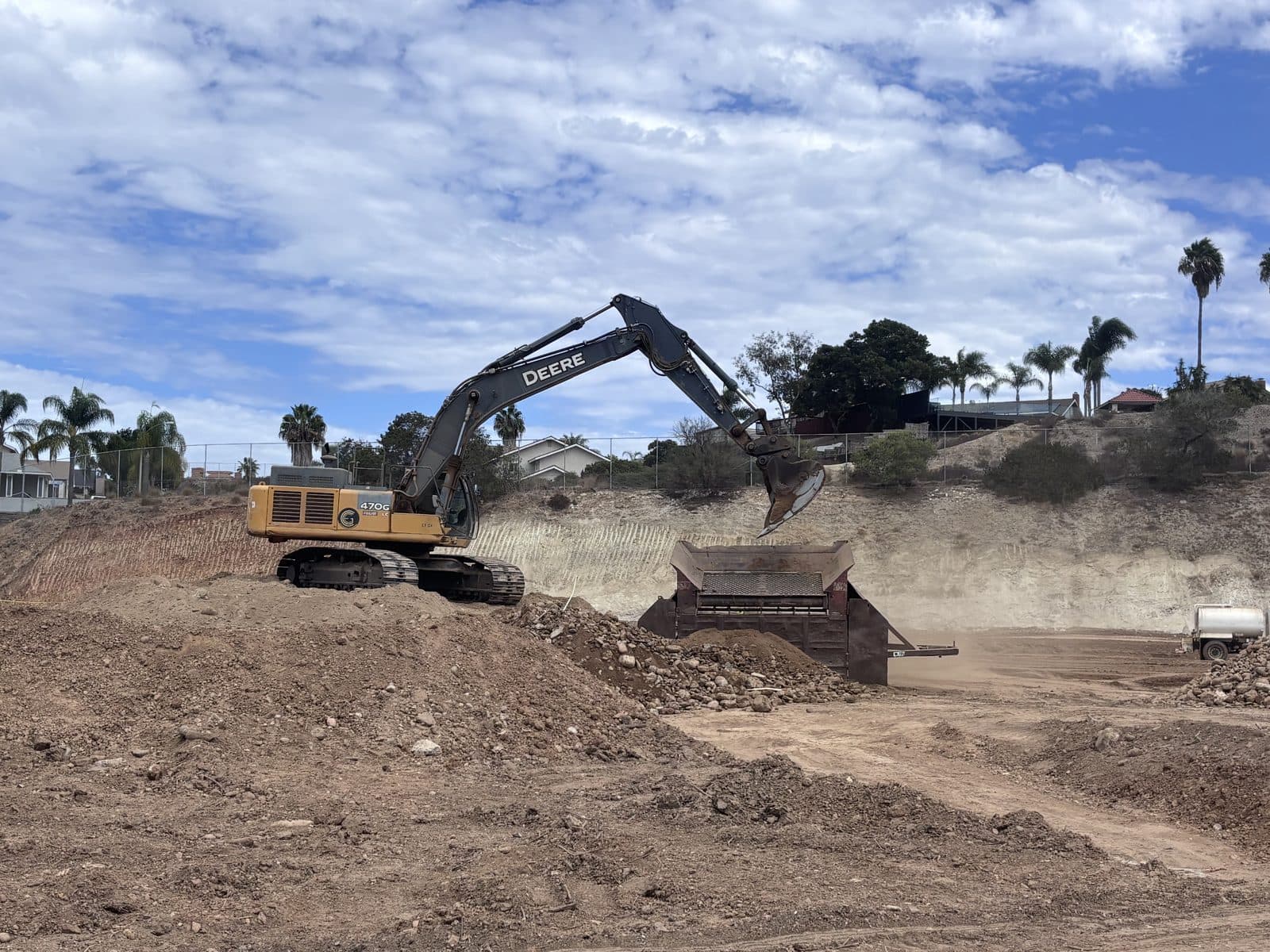 Active earthwork with heavy equipment at a California school construction site