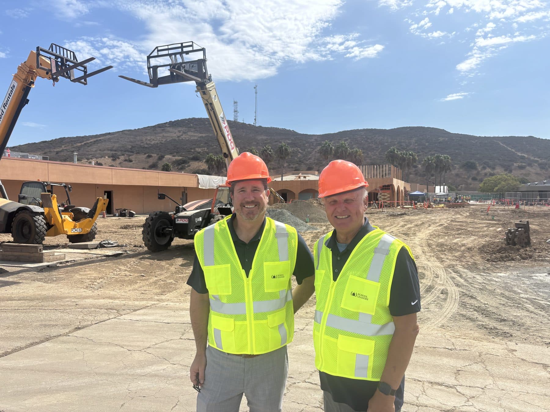 School Leaders team in branded safety vests and hard hats at a California school construction site